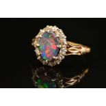 A GOLD EARLY 20TH CENTURY FINE BLACK OPAL AND DIAMOND RING, centring on an oval black oval,