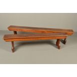 TWO VICTORIAN OAK CHAPEL BENCHES, plain rectangular tops above shaped ends with trefoil cut aways,