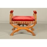 A VICTORIAN OAK STOOL OF GOTHIC DESIGN IN THE STYLE OF PUGIN, with red velvet upholstered padded