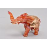 A HAND CARVED CARNELIAN ORNAMENTS DESIGNED AS AN ELEPHANT, elephant carved out of banded orange