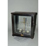 A LATE 19TH CENTURY CASED DIAMOND AND GEMSTONE BALANCE SCALE, fitted with ebonized or polished