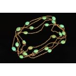 A TURQUOISE GUARD CHAIN, measuring approximately 1400mm in length, comprised oval greenish oval