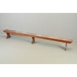 A VICTORIAN OAK LOW TRESTLE STYLE BENCH IN THE MANNER OF EDWARD WELBY PUGIN (1834-1875), single