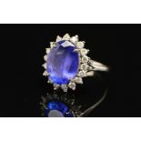 A MODERN LARGE TANZANITE AND DIAMOND OVAL CLUSTER RING, tanzanite measuring approximately 14.3mm x