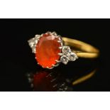A LATE 20TH CENTURY FIRE OPAL DRESS RING, centring on an oval mixed cut fire opal, measuring