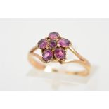 A GARNET CLUSTER RING, designed as a floral cluster ring set with circular and oval shape garnets to