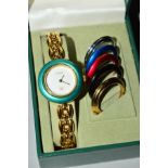 A BOXED GUCCI LADIES WRISTWATCH, with interchangeable bezels, gold coloured hands on a