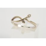 A 9CT WHITE GOLD DIAMOND RING, of asymmetrical design claw set with two brilliant cut diamonds,