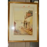 A WATERCOLOUR OF A COTTAGE OVERLOOKING A HARBOUR, indistinctly signed, dated 1921, mounted, framed