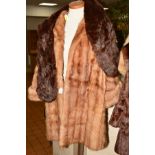 A LIGHT COLOURED LADIES FUR COAT, approximate size 14 together with a dark fur stole