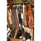 A QUANTITY OF LADIES CLOTHING, to include fur coats, dresses, scarves, belts, leather evening