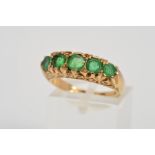 A 9CT GOLD FIVE STONE EMERALD RING, designed as five graduated circular emeralds to the scrolling