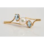 A 9CT GOLD CULTURED PEARL AND TOPAZ BROOCH, designed as a central cultured pearl flanked by pear