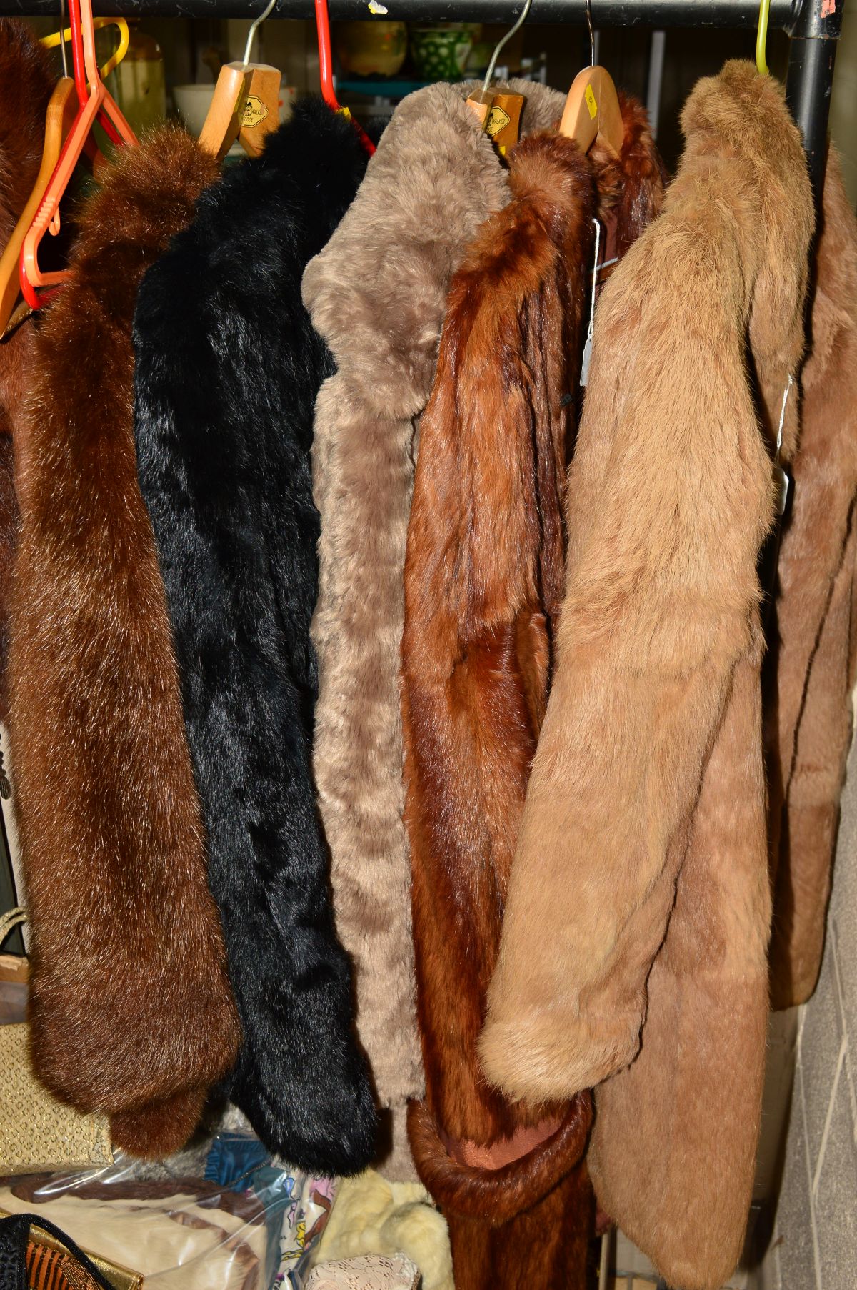 A LIGHT BROWN CONEY FUR JACKET, a black coney fur jacket, a long dyed marmot fur coat (stiff) and