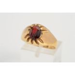 A 9CT GOLD GARNET RING, designed as a claw set oval garnet to the tapered band, with 9ct hallmark