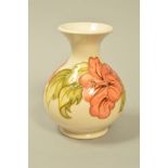 A SMALL MOORCROFT POTTERY VASE, 'Hibiscus' pattern on cream backgound, impressed and painted marks