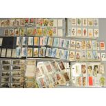 THREE CIGARETTE CARD ALBUMS, containing approximately one thousand four hundred cigarette cards, a