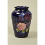 A SMALL MOORCROFT POTTERY VASE, 'Anemone' pattern on blue ground, impressed marks and label to base,