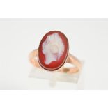 A HARDSTONE CAMEO RING, designed as an oval cameo in a collet setting, stamped 9ct, ring size O,