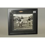 FRAMED BLACK AND WHITE PHOTOGRAPH OF A MATCH IN PROGRESS, Staffordshire vs ??, with Jan Webster in
