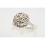 A PLATINUM DIAMOND CLUSTER RING, the tiered cluster claw set with brilliant cut diamonds,