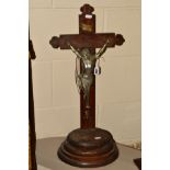 AN ALTER CRUCIFIX, mounted on oak stepped oval base, height 65cm