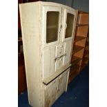 A DISTRESSED KITCHEN CABINET with various doors and drawers