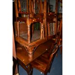 AN OAK EXTENDING DINING TABLE and a set of eight hardwood and wrought iron chairs (9)