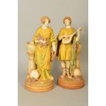 A PAIR OF AMPHORA MUISICIAN FIGURES depicting a young Grecian man playing musical instrument with