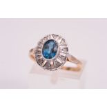 A 9CT GOLD DIAMOND DRESS RING, designed with a central oval blue gem assessed as coated topaz,