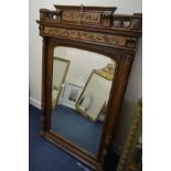 AN EDWARDIAN FRENCH WALNUT OVERMANTEL MIRROR with foliate decoration flanked by fluted columns,