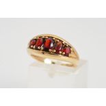 A 9CT GOLD GARNET RING, designed as five oval graduated garnets secured with four claw settings