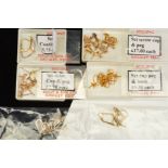 A VARIETY OF LOOSE EARRINGS FINDINGS to include posts, screw backs, hooks and scrolls, all with