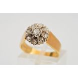 AN 18CT GOLD DIAMOND CLUSTER RING, the tiered cluster with a central brilliant cut diamond within