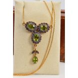 A PERIDOT AND AMETHYST NECKLACE, designed as three clusters of oval peridots within circular