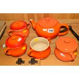 AN ORANGE LE CREUSET TEAPOT AND FOUR COVERED TWIN HANDLED BOWLS, one missing cover (5)
