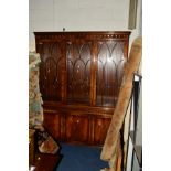 A BEVAN FUNNEL MAHOGANY ASTRAGAL GLAZED TRIPLE DOOR BOOKCASE above a cupboard base, width 170cm x