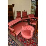A LATE VICTORIAN/EDWARDIAN MATCHED PINK UPHOLSTERED SALON SUITE, comprising settee, tub chair,