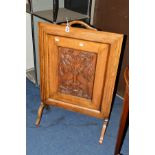 AN EARLY 20TH CENTURY OAK FIRESCREEN with a carved decoration of a pair of doves and foliage