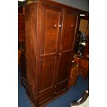 AN EARLY 20TH CENTURY PANELLED OAK DOUBLE CUPBOARD above a double cupboard door section, width