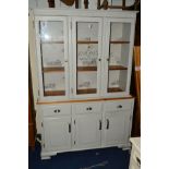 A MODERN PAINTED PINE GLAZED TRIPLE DOOR BOOKCASE with three drawers, width 128cm x depth 41cm x