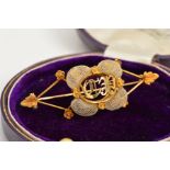 A VICTORIAN HAIR BROOCH, centring on initials C.P., enclosed within an intricate woven white hair