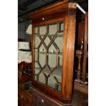 A GEORGIAN OAK ASTRAGAL GLAZED SINGLE DOOR HANGING CORNER CUPBOARD with a painted interior