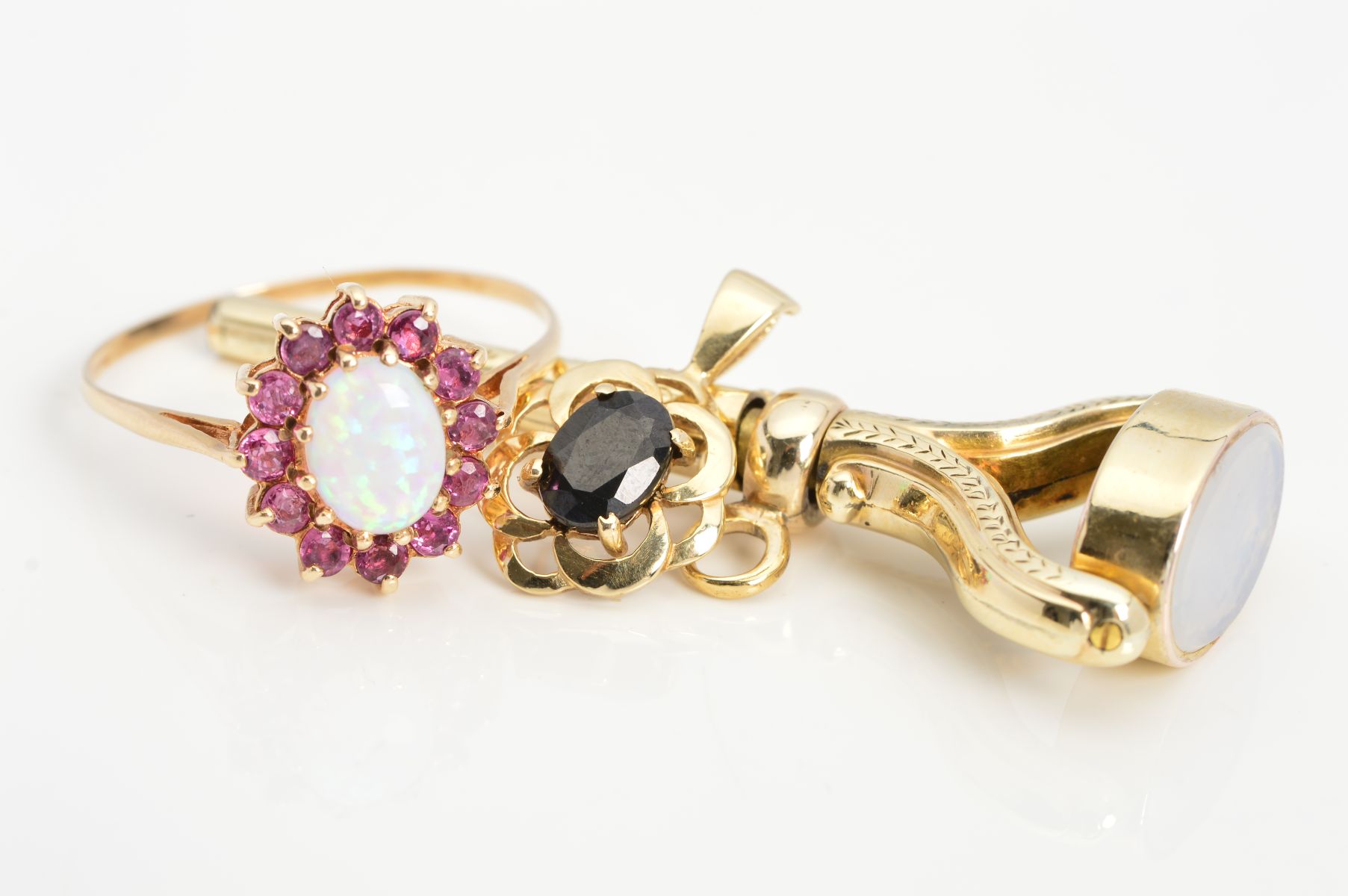 THREE ITEMS OF JEWELLERY, to include a 9ct gold gem ring designed as a central oval simulated opal