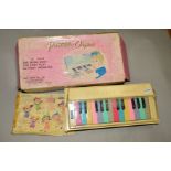 A 1960'S/70'S JAPANESE BATTERY OPERATED 24 KEY PORTABLE ORGAN, in original box with colour coded