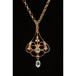 A 9CT GOLD GEM PENDANT AND CHAIN, the pendant of scrolling openwork design set with aquamarines,
