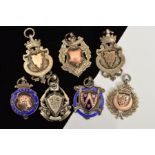 SEVEN SILVER SPORTING MEDALS, most of shield shape outline, two with blue enamel detail, many with