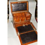 AN EDWARDIAN OAK STATIONERY BOX, hinged lid opening to reveal a fold out slope and assorted drawers,