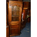A REPRODUCTION OAK CORNER CUPBOARD and an oak single door cupboard with two long drawers (2)