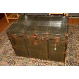 AN EARLY 20TH CENTURY METAL BOUND TRAVELLING TRUNK OF RECTANGULAR FORM, bears brass plaque